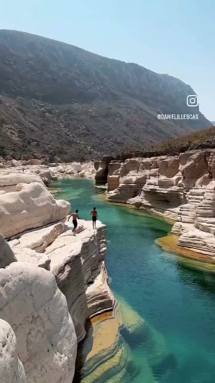 Instagram Reels source video at 1 second showing the dual watermark — Instagram logo and @username overlay in the bottom-right corner